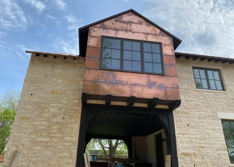 Copper metal panel facade on a stone building for Roof Repair in City of Orange