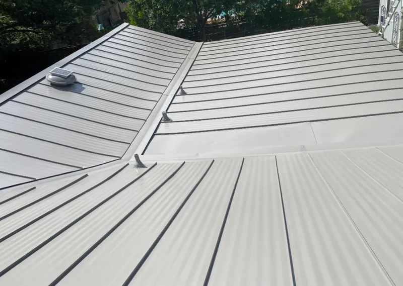 Solar attic fan installed on a metal roof for Roof Ventilation in City of Orange