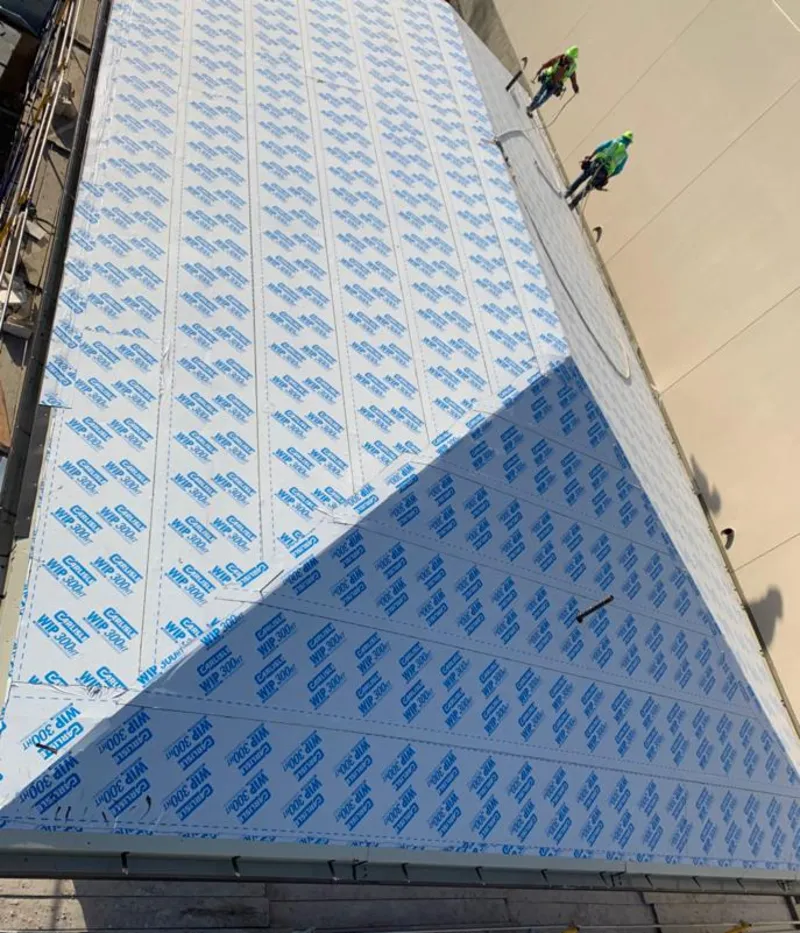 Professional roofers installing underlayment on a metal roof in City of Orange